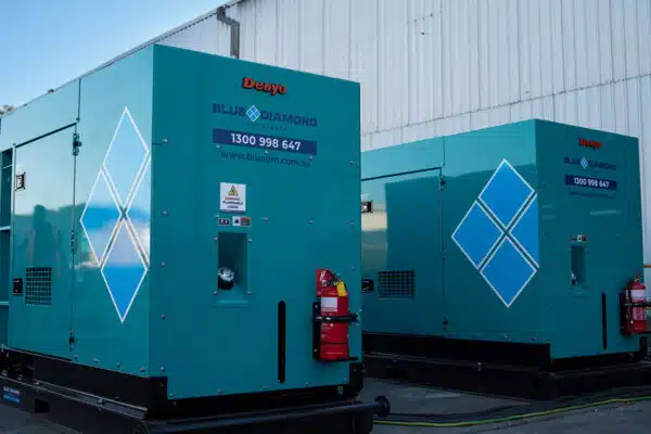 Two Denyo diesel generators standing side by side from Blue Diamond Machinery.