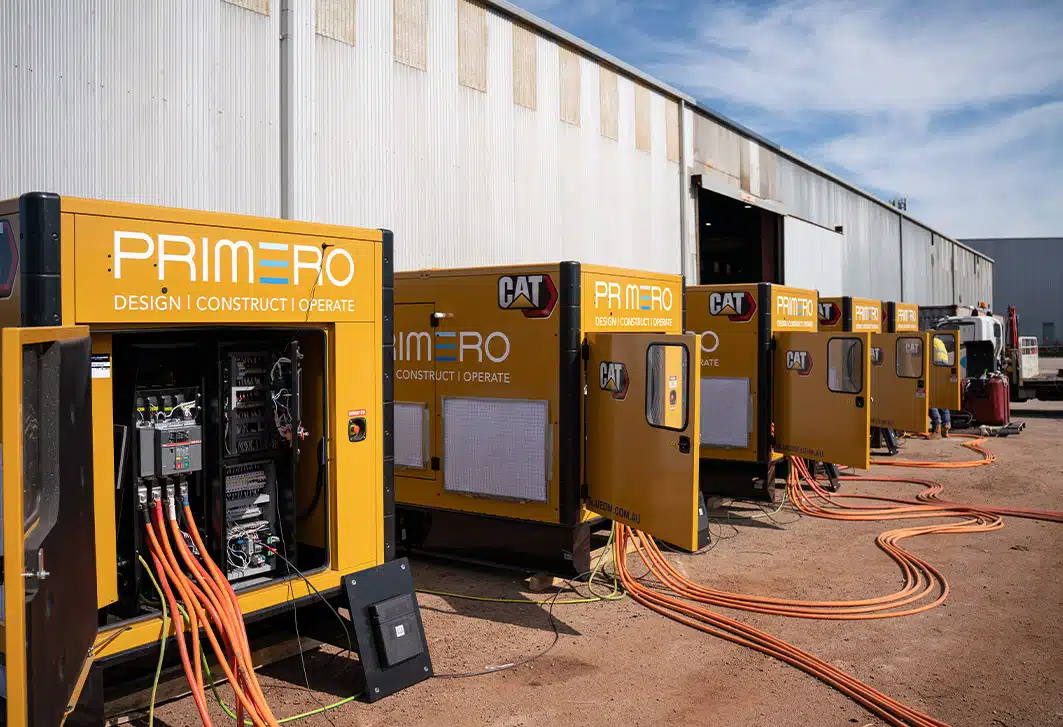Five Primero diesel generators hooked up for generator synchronisation at a work site.