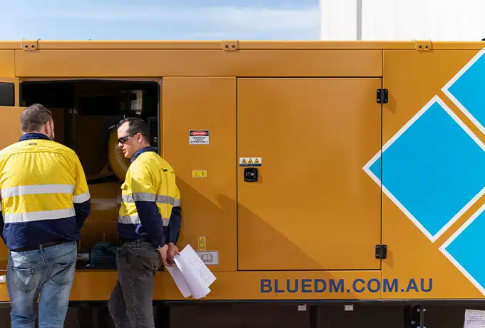 Two workers operating a Primero diesel Generator with Blue Diamond Machinery