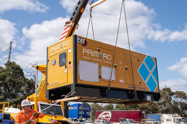 Crane hoisting a diesel generator for an off-grid Lithium Crushing Plant