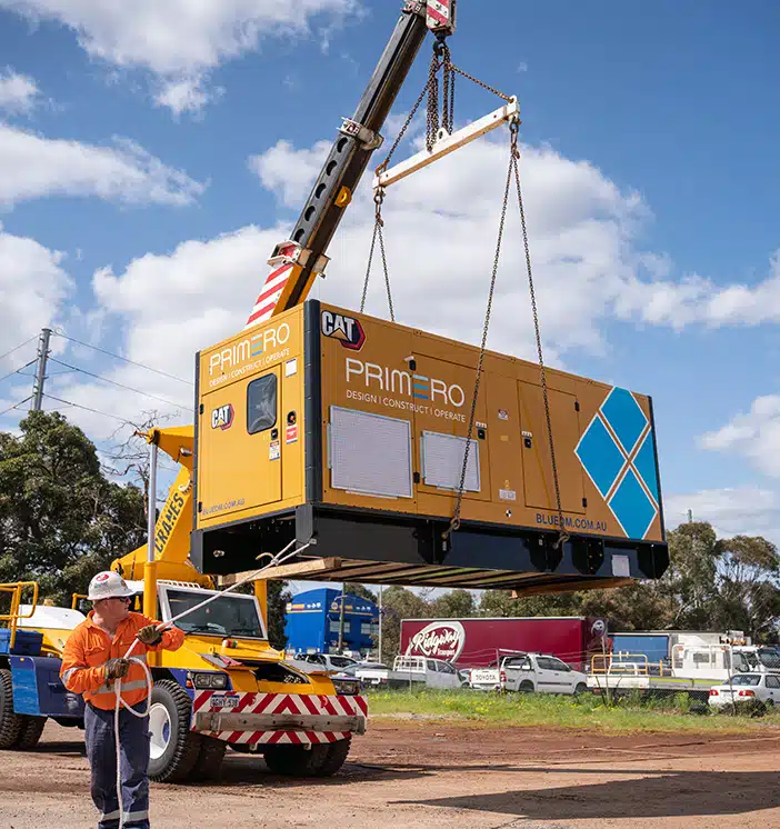 Crane hoisting a diesel generator for an off-grid Lithium Crushing Plant